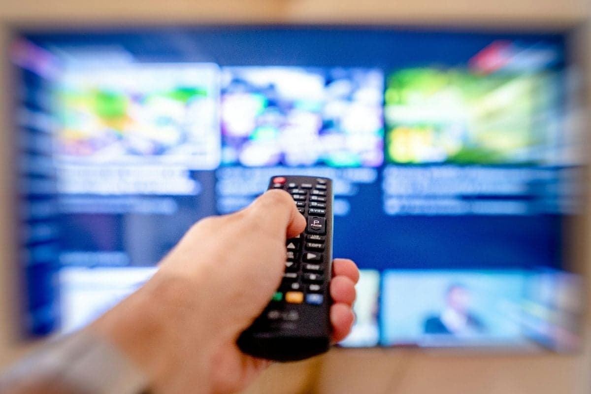 Amazon Prime Video Sued Over Ads Added to Standard Plan 3 TV remote pointing at TV. / amazon prime video