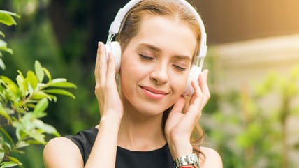 Woman Listening To Music On Headphones. / Amazon Music Unlimited