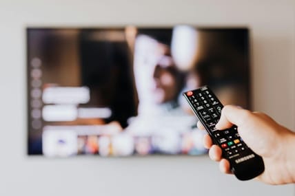 Person-With-Remote-Changing-Channel / Youtube Tv