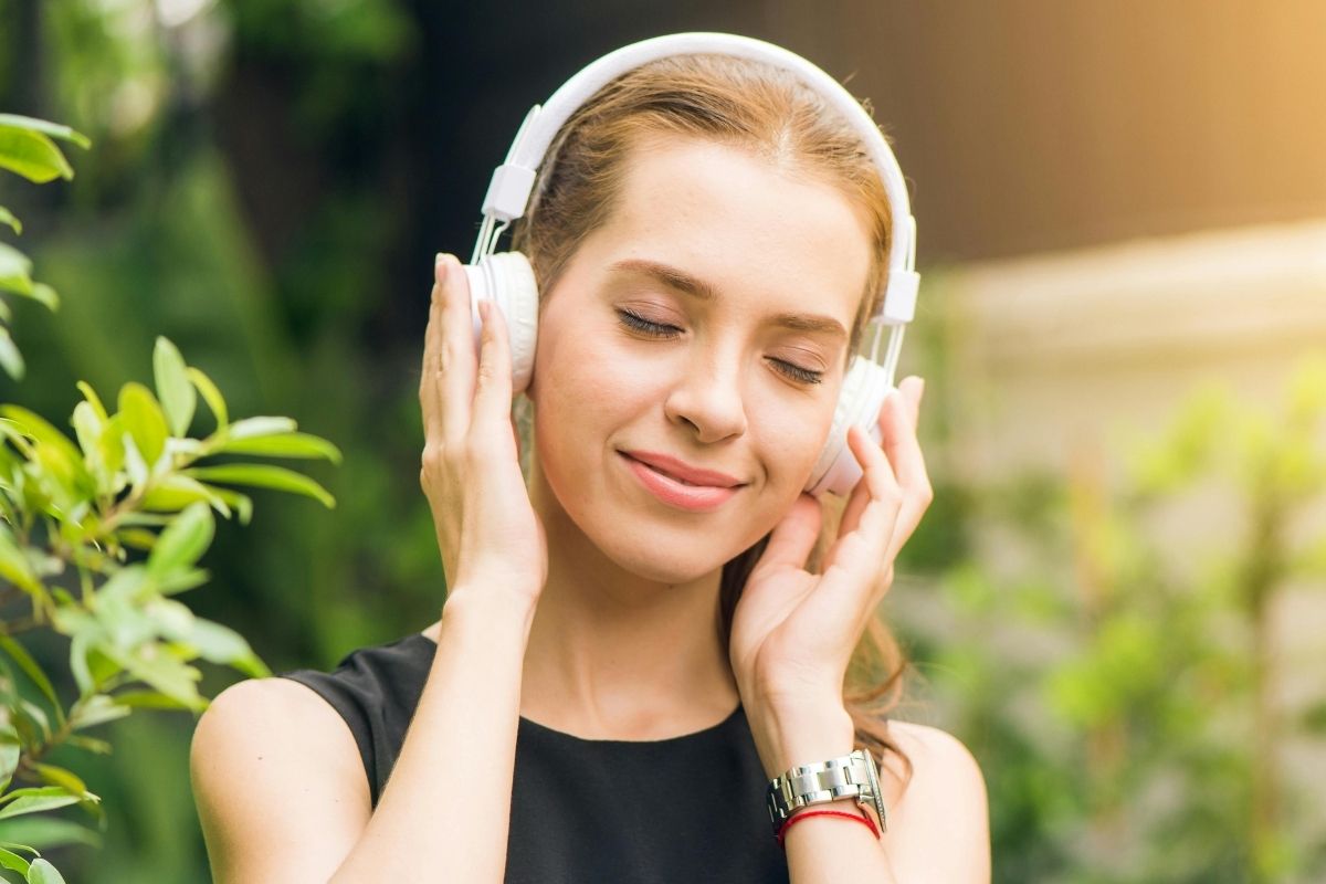 Woman Listening To Music On Headphones. / Amazon Music Unlimited