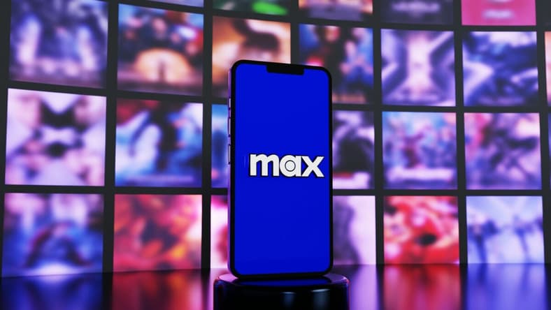 Hbo Max Logo On Phone In Front Of Screens