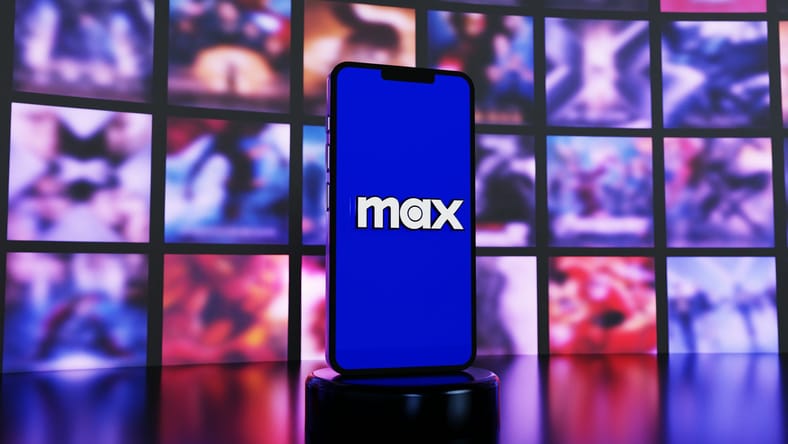 Hbo Max Logo On Phone In Front Of Screens