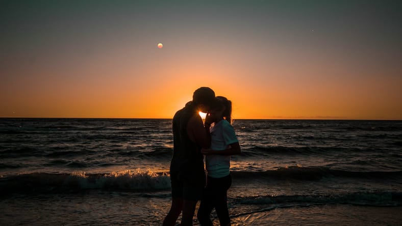 Couple Kissing At Sunset / Steamy Romance Movies