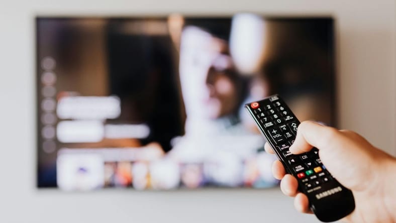 Person-With-Remote-Changing-Channel / Youtube Tv