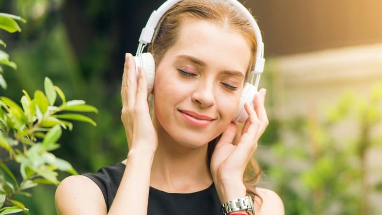 Woman Listening To Music On Headphones. / Amazon Music Unlimited